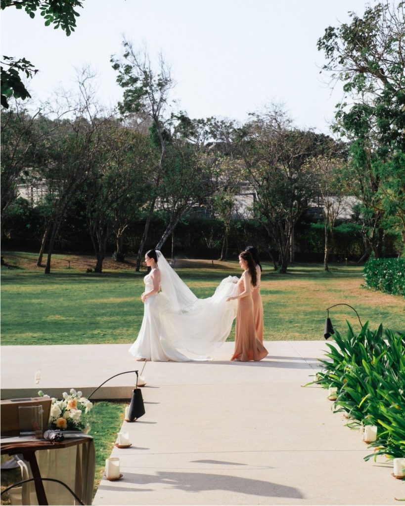 Bride walking with a bridesmaid outdoors.